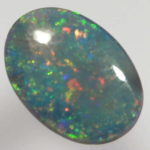 SOLID BLACK OPAL Sparkling reds, yellows over ocean blue